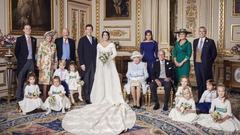 Princess Eugenie and her husband, Jack Brooksbank, stand next to Queen Elizabeth and Prince Philip following their wedding on October 12. Seated next to Brooksbank are Prince George and Princess Charlotte. Eugenie's sister, Princess Beatrice, and parents, Sarah, Duchess of York, and Prince Andrew, appear on the right.