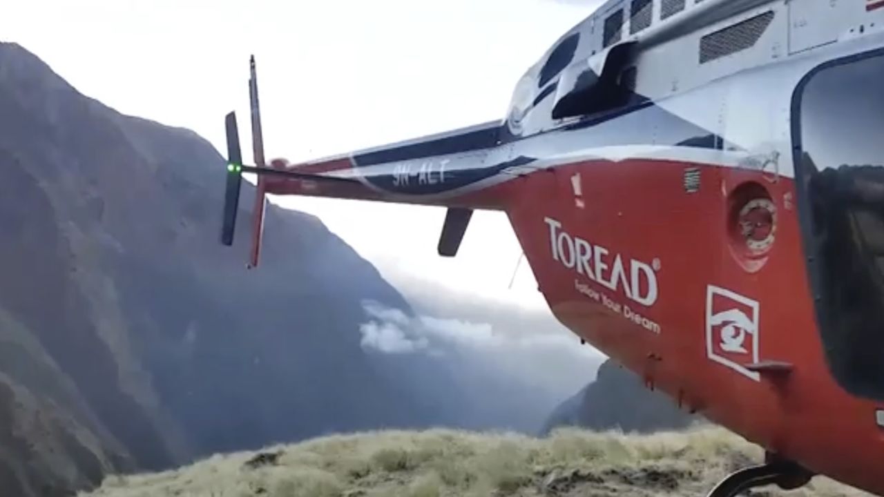 A helicopter lands close to a storm site Saturday after searching for missing climbers on Mt. Gurja.