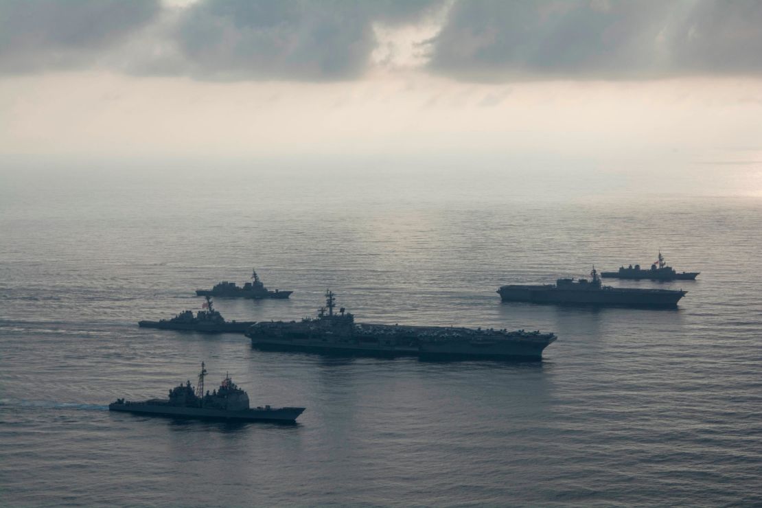 The aircraft carrier USS Ronald Reagan, second from bottom,  the guided-missile cruiser USS Antietam, bottom, and the guided-missile destroyer USS Milius, left, conduct a photo exercise with the Japan Maritime Self-Defense Force helicopter destroyer JS Kaga , second from top, and the JMSDF destroyers JS Inazuma and JS Suzutsuki . 