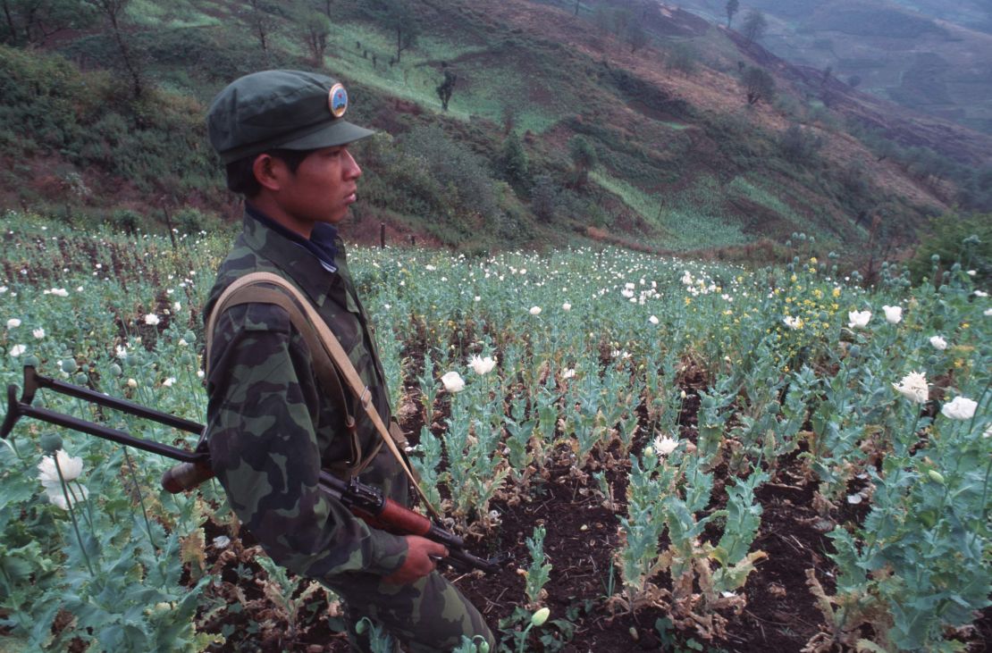 A United Wa State Army soldier in a poppy field in 1995.