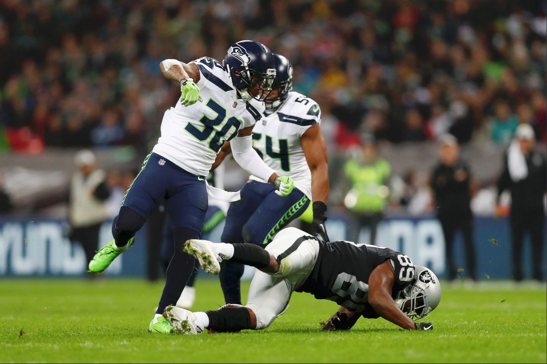 McDougald tackles Cooper in the NFL game at Wembley Sunday.