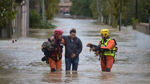 Firefighters help a resident in Trebes, near Carcassonne, southern France.