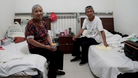 Cao Ruizhe and her huband, Yao Shuping, sit in their rented hotel room, awaiting her next cancer treatment.