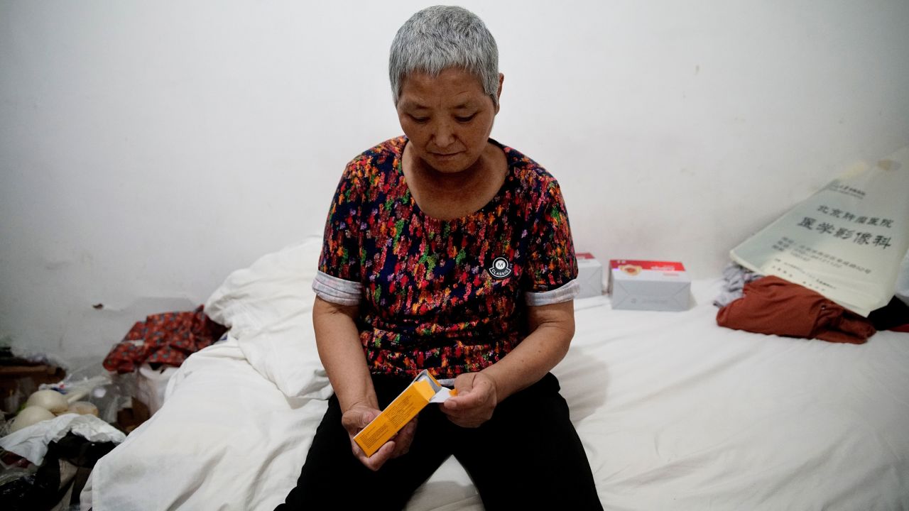 Cao Ruizhe in her rented hotel room, awaiting her next cancer treatment.