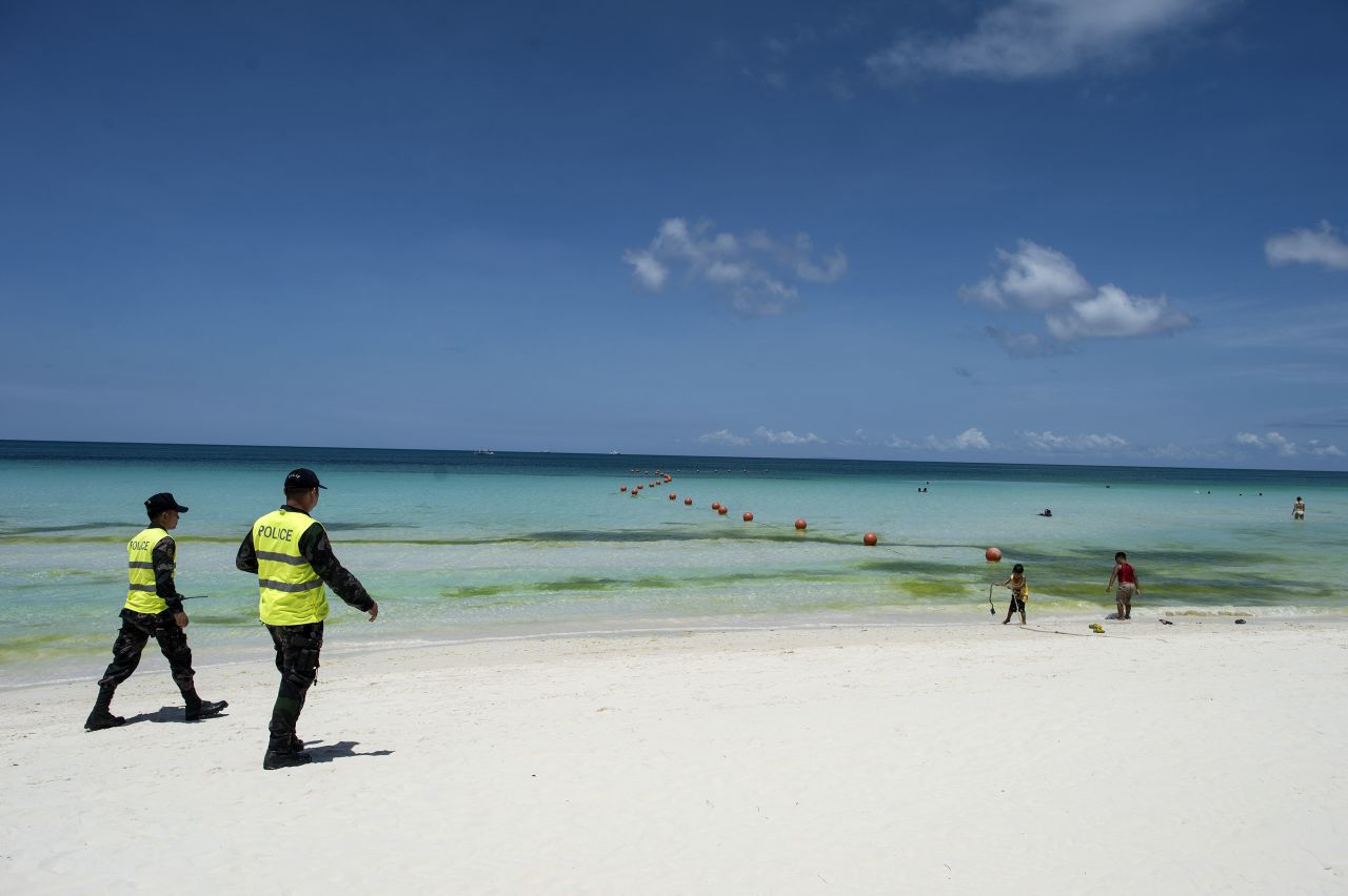 Policemen patrol on the beach on Philippine island of Boracay on April 26, 2018.