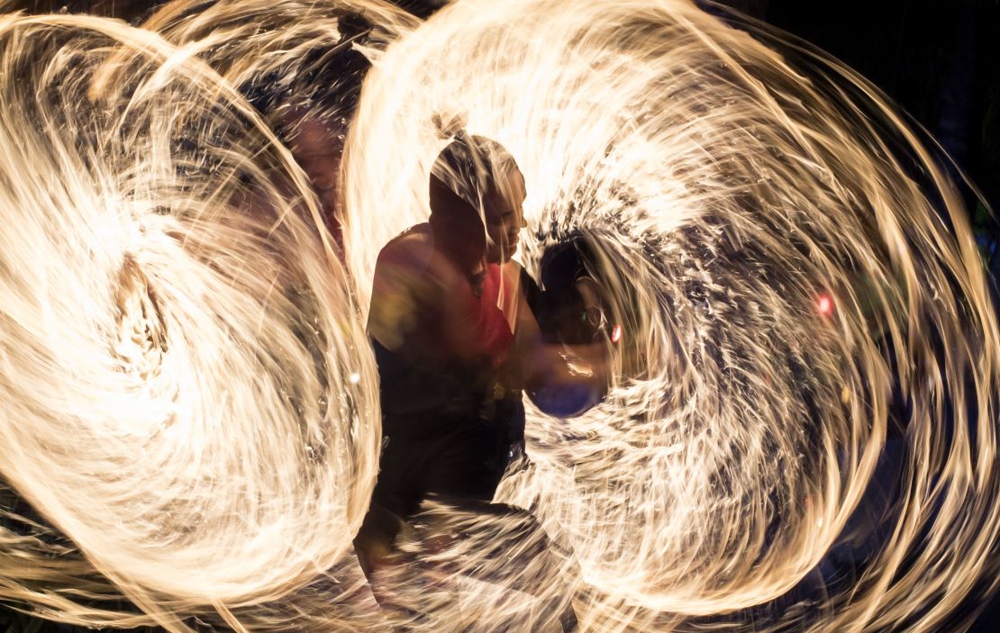 A fire dancer performs for tourists before the shutdown in April 2018.