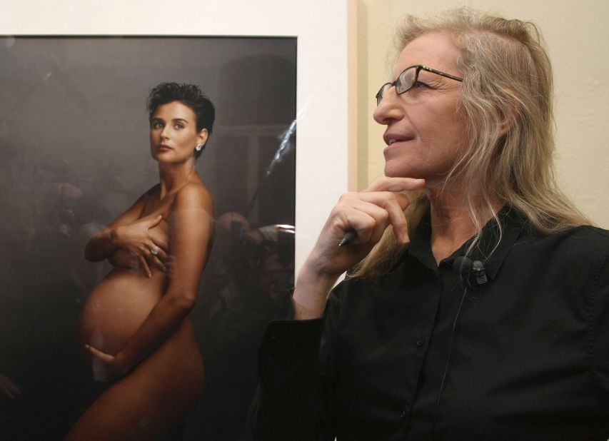 Photographer Annie Leibovitz stands in front of the iconic portrait of pregnant actress Demi Moore, who Leibovitz photographed for the August 1991 cover of Vanity Fair.