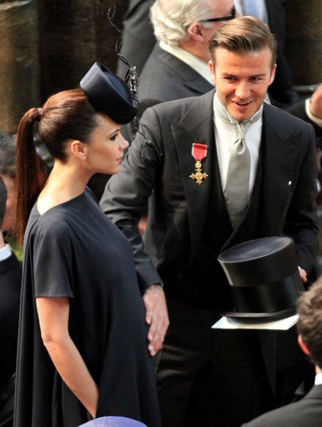 David Beckham pats the tummy of his pregnant wife Victoria Beckham, as they attend the Royal Wedding of Prince William to Catherine Middleton at Westminster Abbey on April 29, 2011 in London.