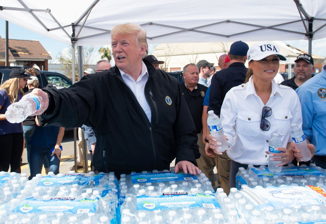 The President and first lady hand out bottles of water to people in Lynn Haven on October 15.