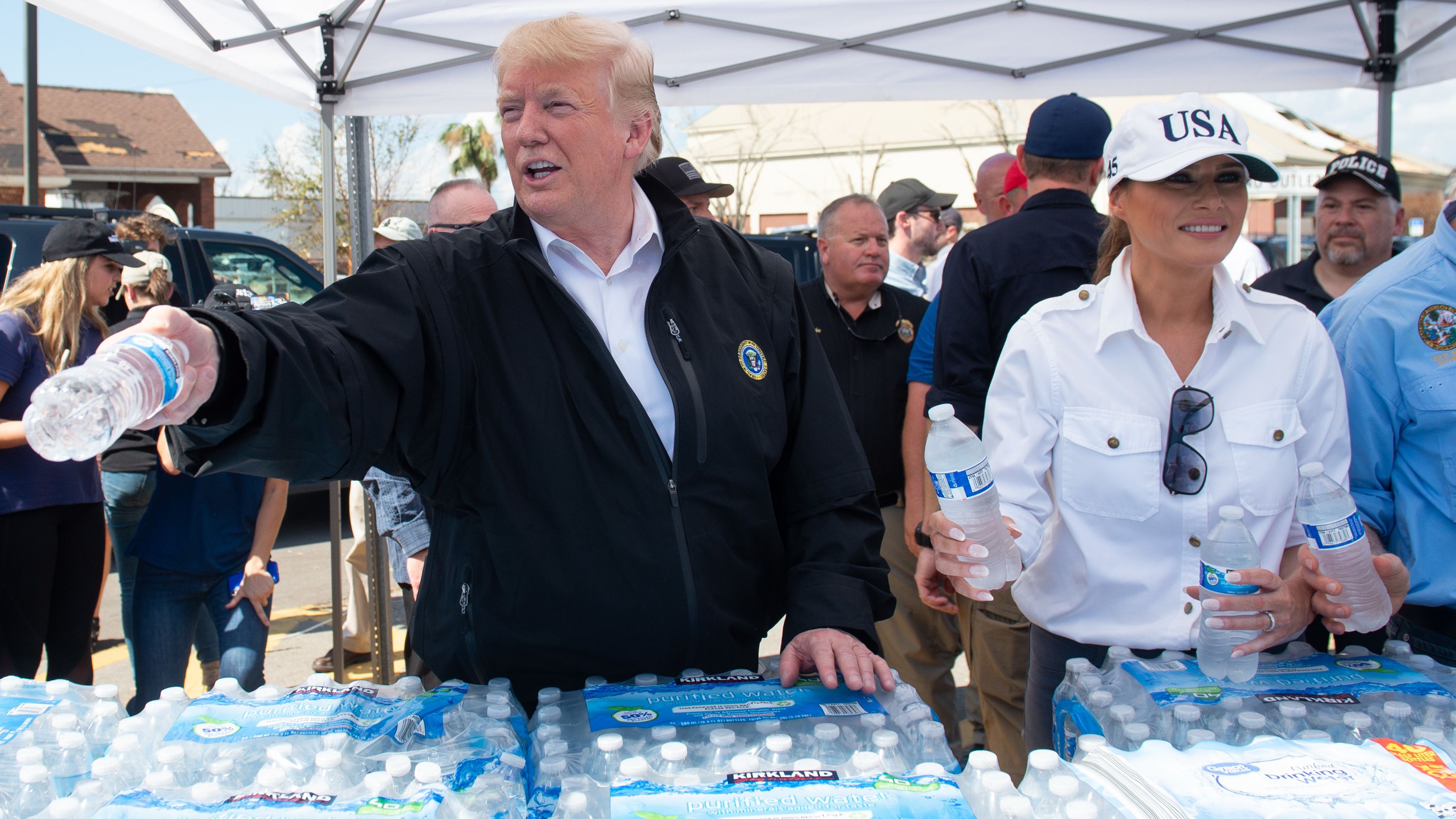The President and first lady hand out bottles of water to people in Lynn Haven on October 15.