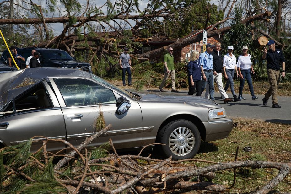 President Donald Trump, first lady Melania Trump and Florida Gov. Rick Scott tour a Lynn Haven, Florida, neighborhood that was affected by Hurricane Michael.