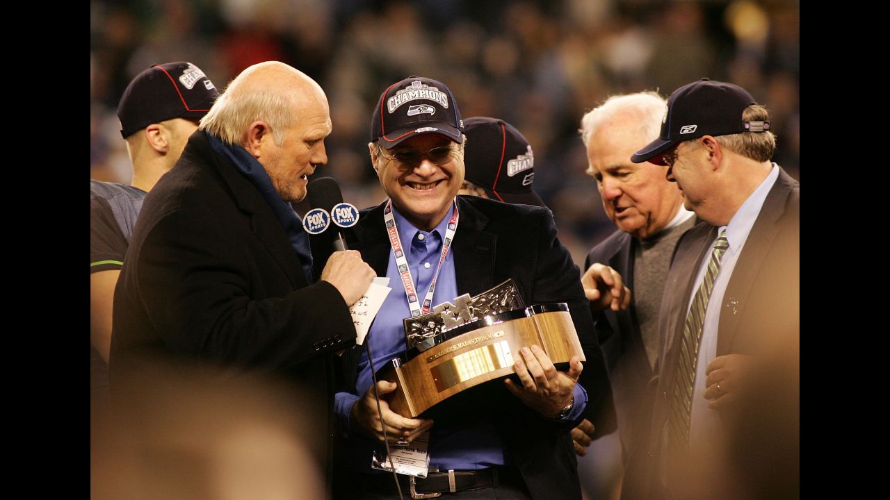 Seahawks owner Paul Allen holds up the NFC Championship trophy following his team's victory over the Carolina Panthers at Qwest Stadium on January 22, 2006.
