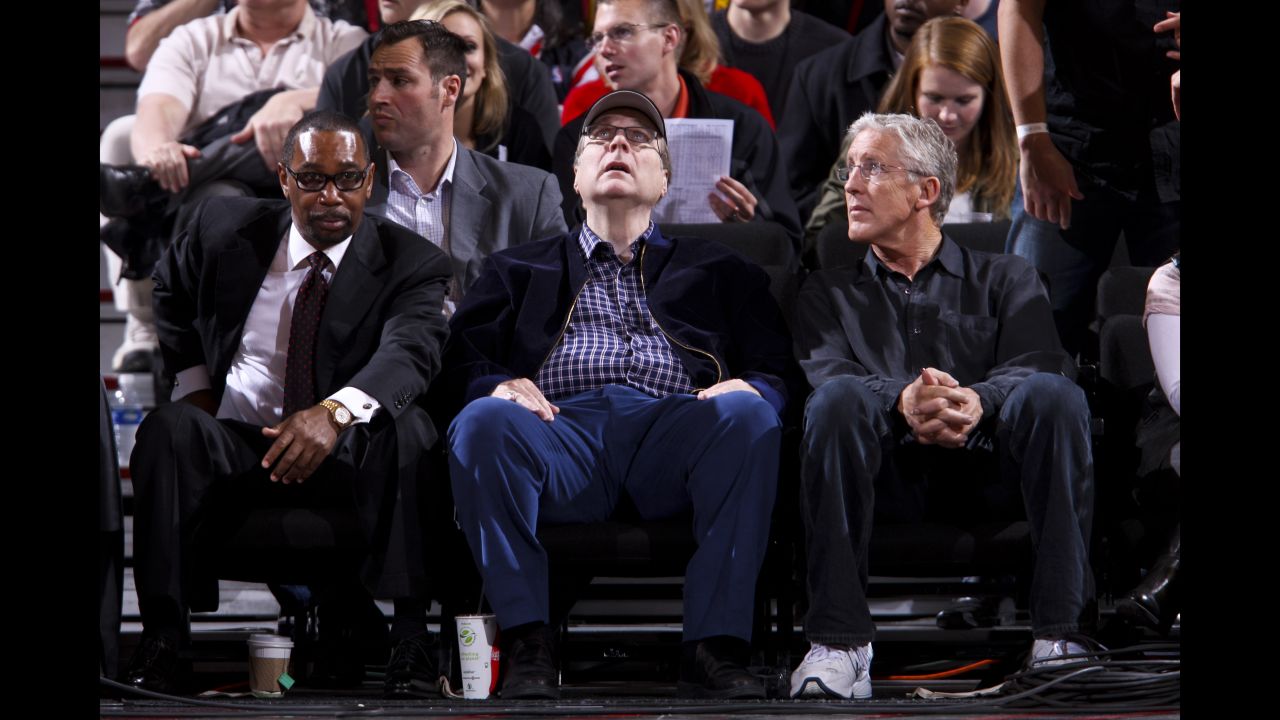 Paul Allen, owner of the Portland Trail Blazers, center, sits with team president Larry Miller, left, and Pete Carroll, head coach of the National Football League's Seattle Seahawks, during a Blazers game against the Utah Jazz on April 18, 2012, at the Rose Garden Arena in Portland, Oregon.