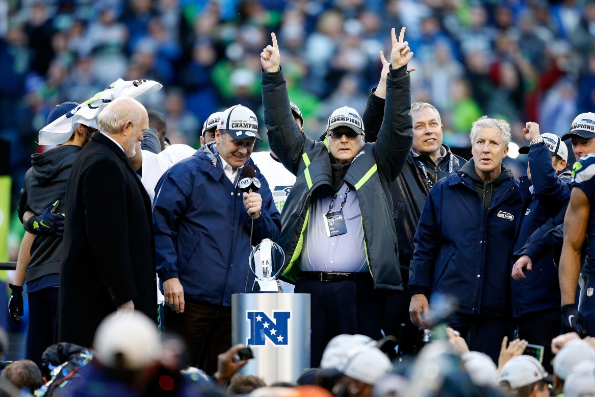 Seattle Seahawks owner Paul Allen and head coach Pete Carroll of the Seattle Seahawks celebrate after the Seahawks defeated the Green Bay Packers in the 2015 NFC Championship game at Century Link Field on January 18, 2015 in Seattle, Washington.