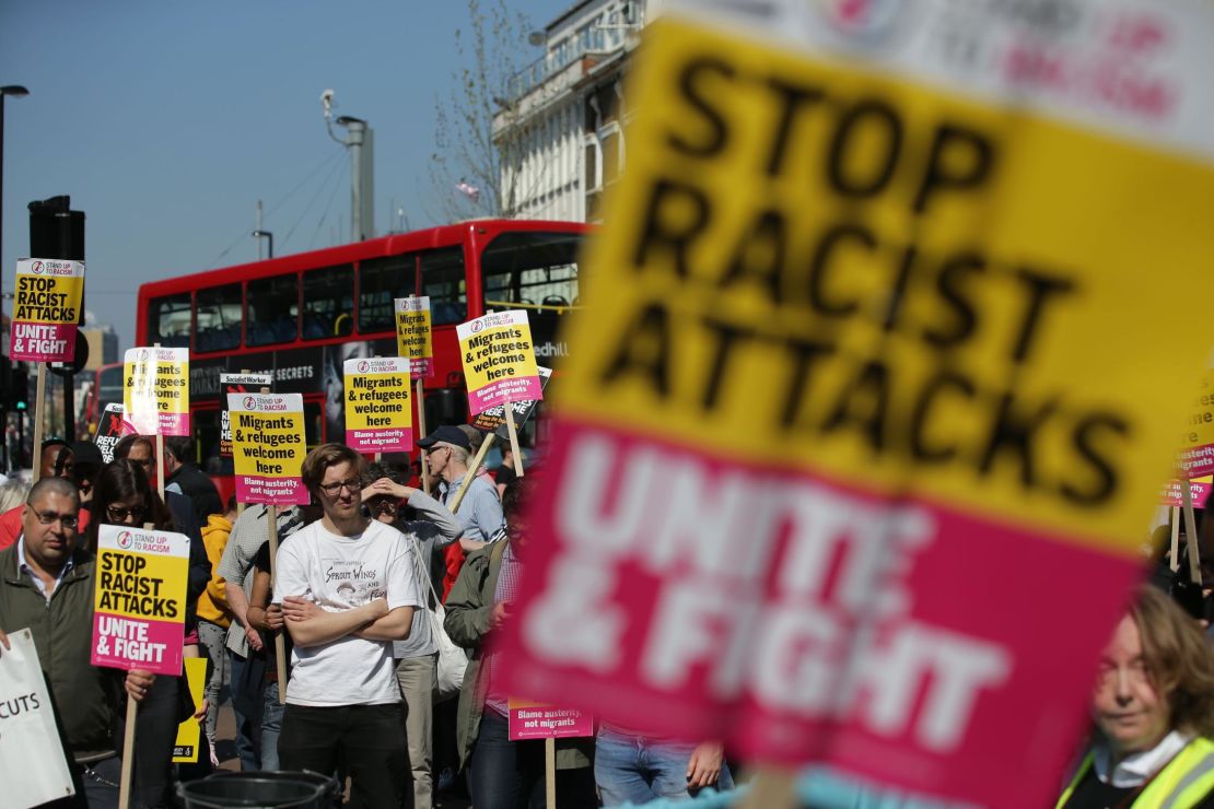 Demonstrators gather with placards during a protest called by the 'Stand Up to Racism' group in Croydon, South London, on April 8, 2017.