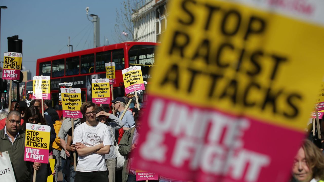 Demonstrators gather with placards during a protest called by the 'Stand Up to Racism' group in Croydon, South London, on April 8, 2017.