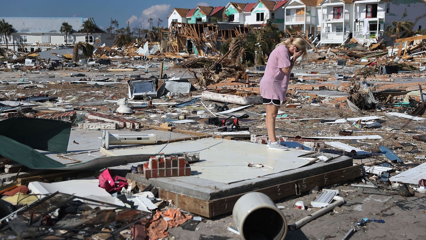 A woman weeps over the remains of her Mexico Beach, Florida, home after it was destroyed by Hurricane Michael in 2018. As coronavirus spreads, scientists are projecting active seasons for natural disasters across the US this year.