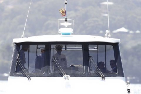 The Duke and Duchess ride in a boat across the Sydney Harbor en route to the opera house.