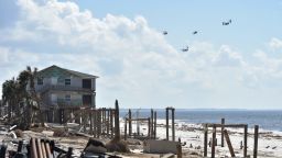 The presidential helicopter Marine One is seen flying along with Osprey planes over the areas destroyed by Hurricane Michael, in Mexico Beach, on October 15, 2018. - HECTOR RETAMAL/AFP/Getty Images