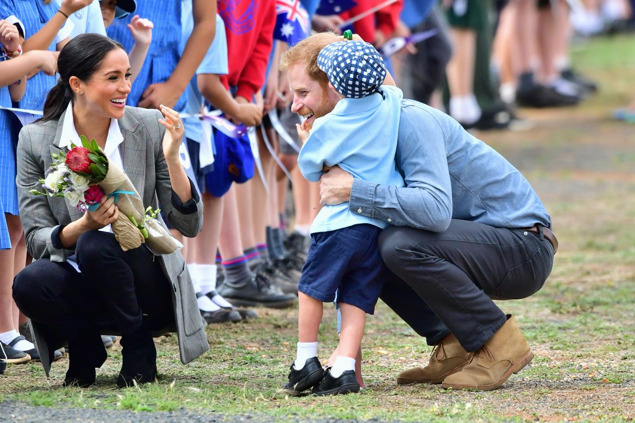 Harry and Meghan are greeted by 5-year-old Luke Vincent as they arrive on Wednesday, October 17, in Dubbo, Australia.