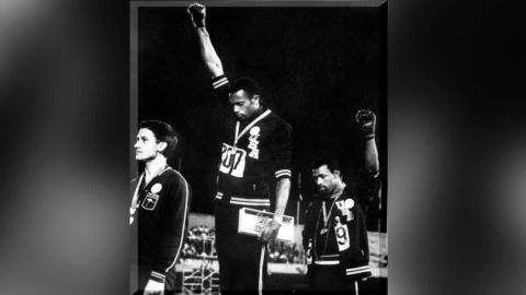 Tommie Smith (center) and John Carlos (right) on the podium at the 1968 Mexico Olympics.