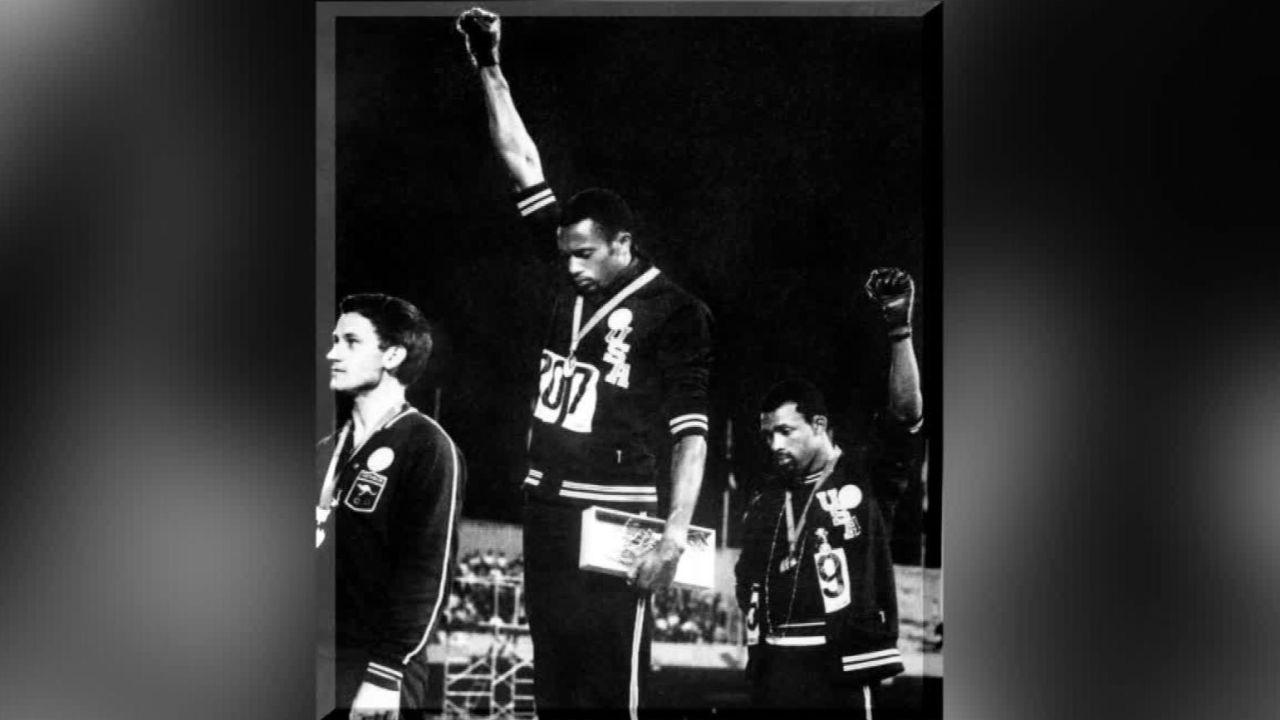 Tommie Smith (center) and John Carlos (right) on the podium at the 1968 Mexico Olympics.