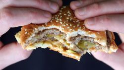 BRISTOL, ENGLAND - JANUARY 07:  In this photo-illustration a man holds a burger purchased from a fast food outlet on January 7, 2013 in Bristol, England.  A government-backed TV advert - made by Aardman, the creators of Wallace and Gromit - to promote healthy eating in England, is to be shown for the first time later today. England has one of the highest rates of obesity in Europe - costing the NHS 5 billion GDP each year - with currently over 60 percent of adults and a third of 10 and 11 year olds thought to be overweight or obese.  (Photo by Matt Cardy/Getty Images)