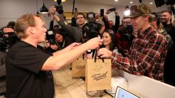 Canopy Growth CEO Bruce Linton hands Ian Power, who is first in line to purchase the first legal recreational marijuana after midnight, his purchases at a Tweed retail store in St John's, Newfoundland and Labrador, Canada October 17, 2018.  REUTERS/Chris Wattie