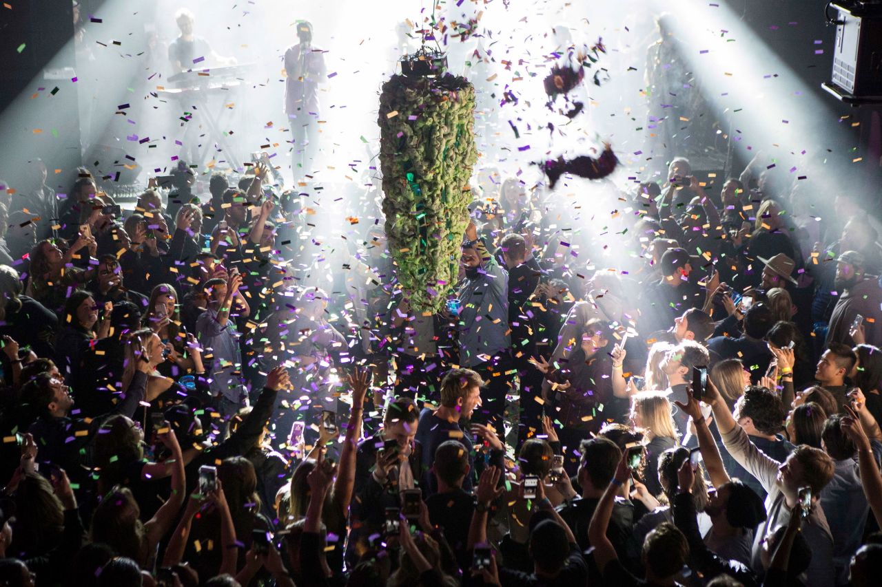A depiction of a marijuana flower bud drops from the ceiling at a Leafly's countdown party in Toronto.