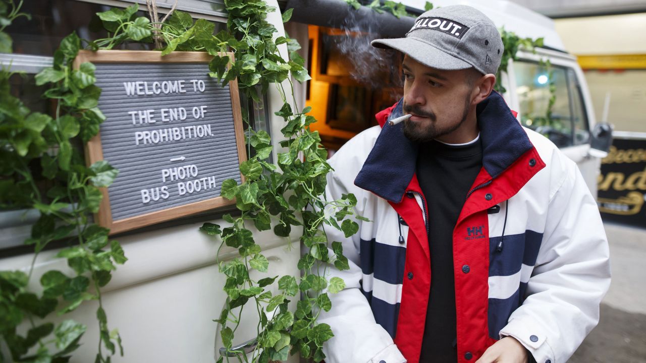 A man smokes a joint during a "Wake 'N Bake" event in Toronto on Wednesday, October 17. It was the first day that marijuana could be sold legally in Canada.