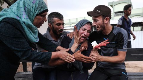A Palestinian woman is comforted after learning of the death of a relative, Naji al-Zaanin, 25, in an Israeli airstrike in Gaza.