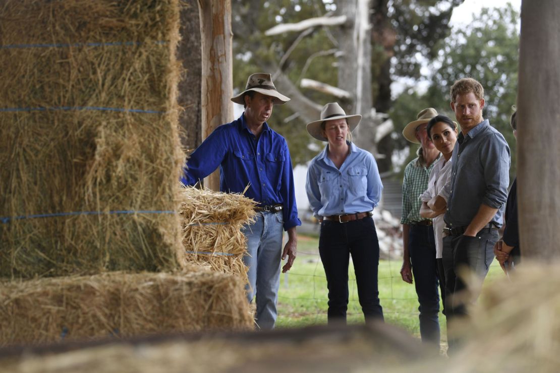Prince Harry and wife Meghan chat with farmers Scott Woodley, his daughter Laura and wife Elaine during a visit to their drought-affected farm in Dubbo.