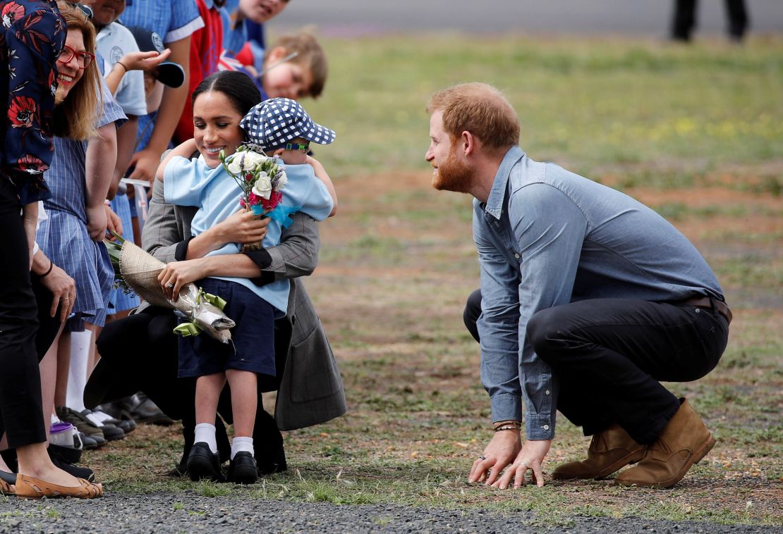 Meghan, Duchess of Sussex, gets a hug and a bouquet of flowers from 5-year-old Luke Vincent.