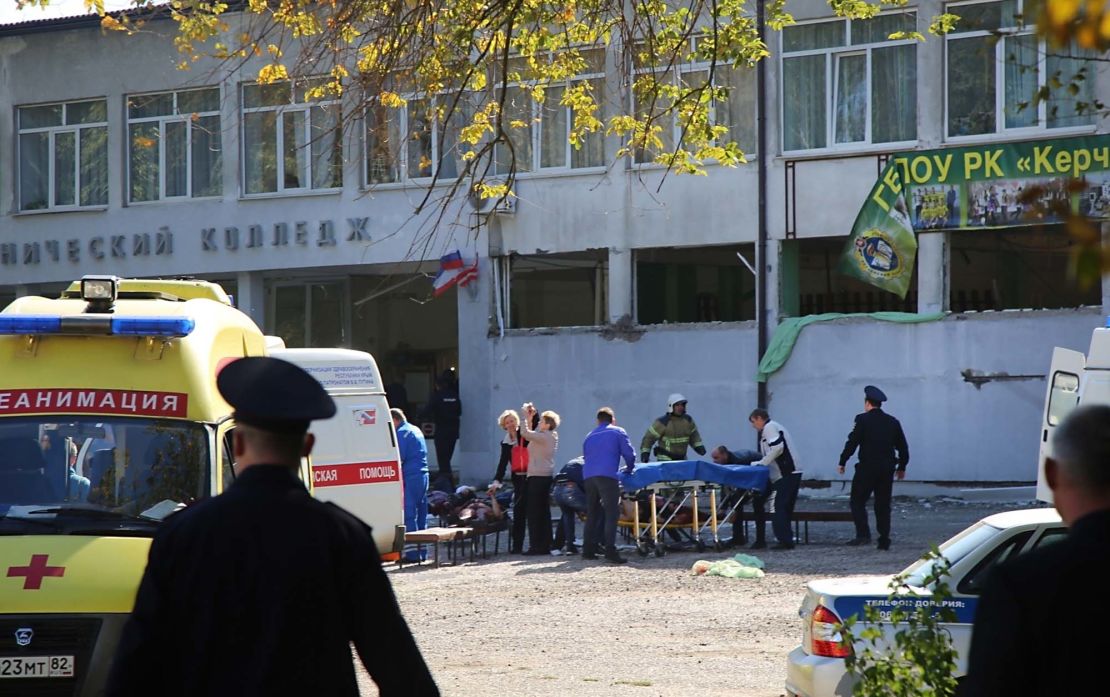 Medical workers treat injured people outside the college building in Kerch, Crimea.