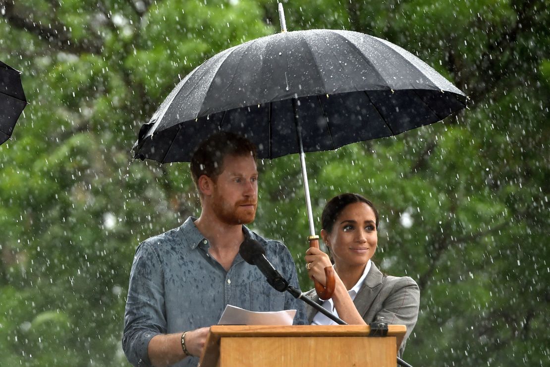 Prince Harry speaks as a rare, welcome outbreak of rain falls in Dubbo, in rural New South Wales.