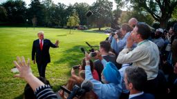 President Donald Trump talks with reporters on the South Lawn of the White House, Tuesday, Oct. 9, 2018, in Washington.