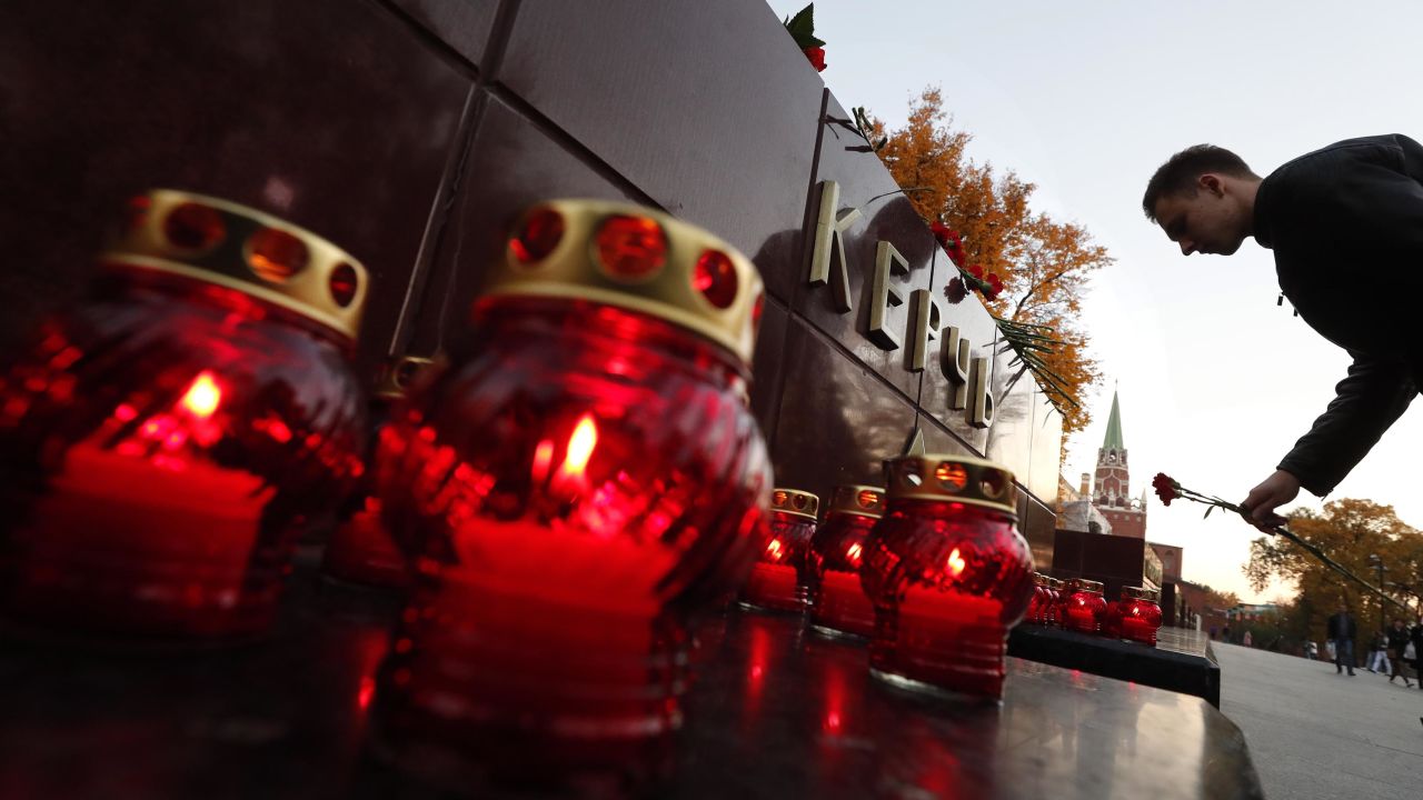 A man lays flowers on the monument to the hero-city of Kerch in the Alexander Garden as a sign of mourning for those killed in the attack in Kerch, Crimea.