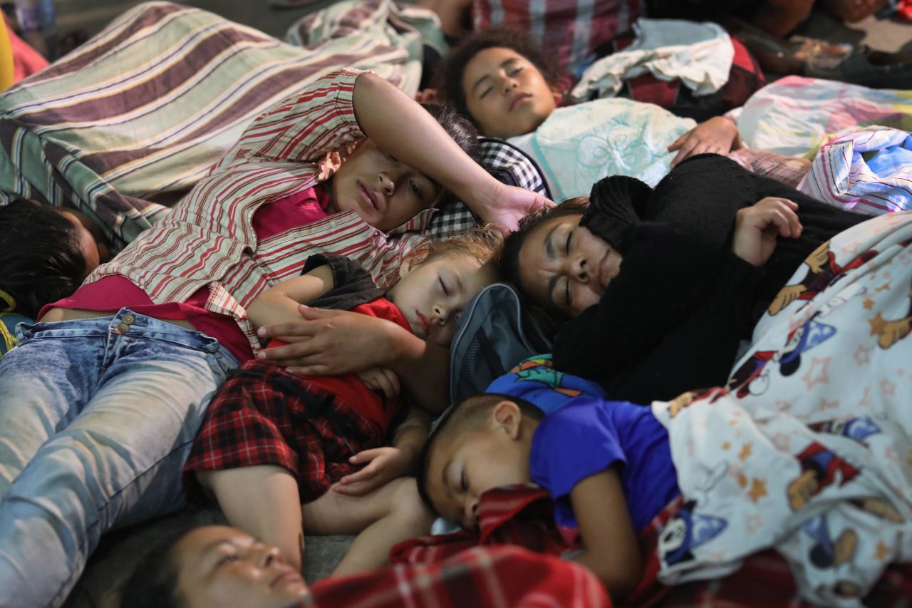 Families in the caravan rest for the night in a community gym on Tuesday in Chiquimula, Guatemala. The caravan is the second of its size in 2018.