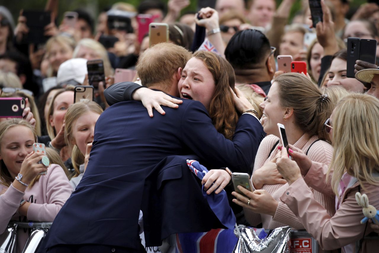 Harry hugs a member of the public as he arrives on Thursday, October 18, at the Royal Botanic Gardens in Melbourne, Australia.