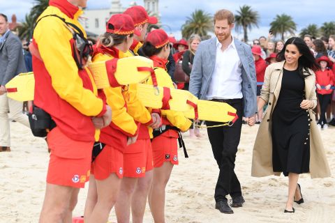Harry and Meghan speak with surf life savers at South Melbourne beach.