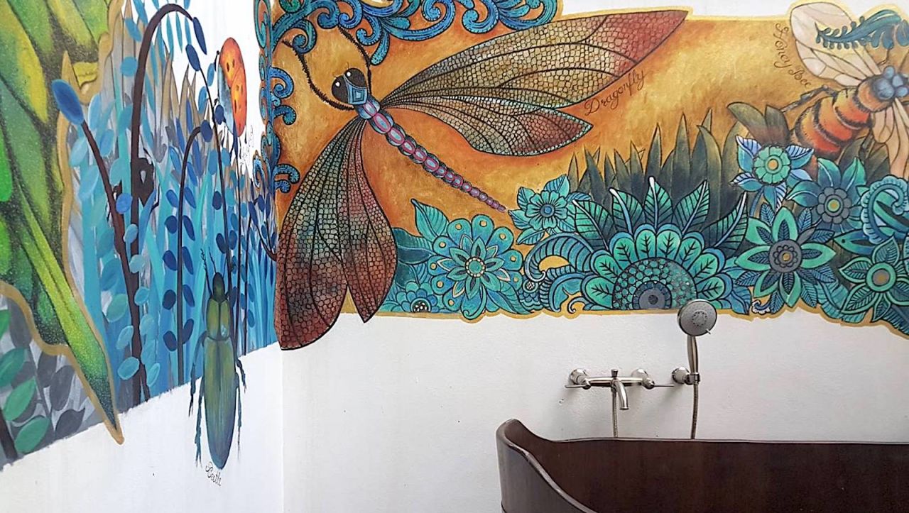 <strong>Dragon fly mural: </strong>The walls of the villa's open-air bathing area feature a beautiful mural. 
