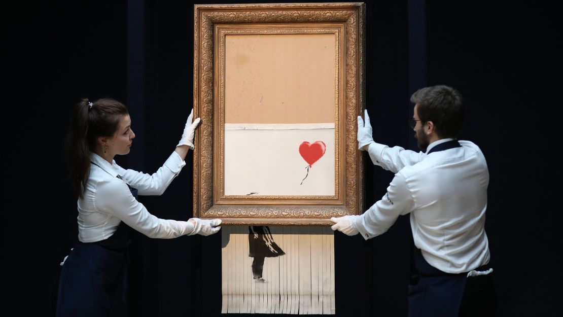 Sotheby's unveils Banksy's newly-titled "Love is in the Bin" at Sotheby's, which passed through a hidden shredder seconds after the hammer fell.