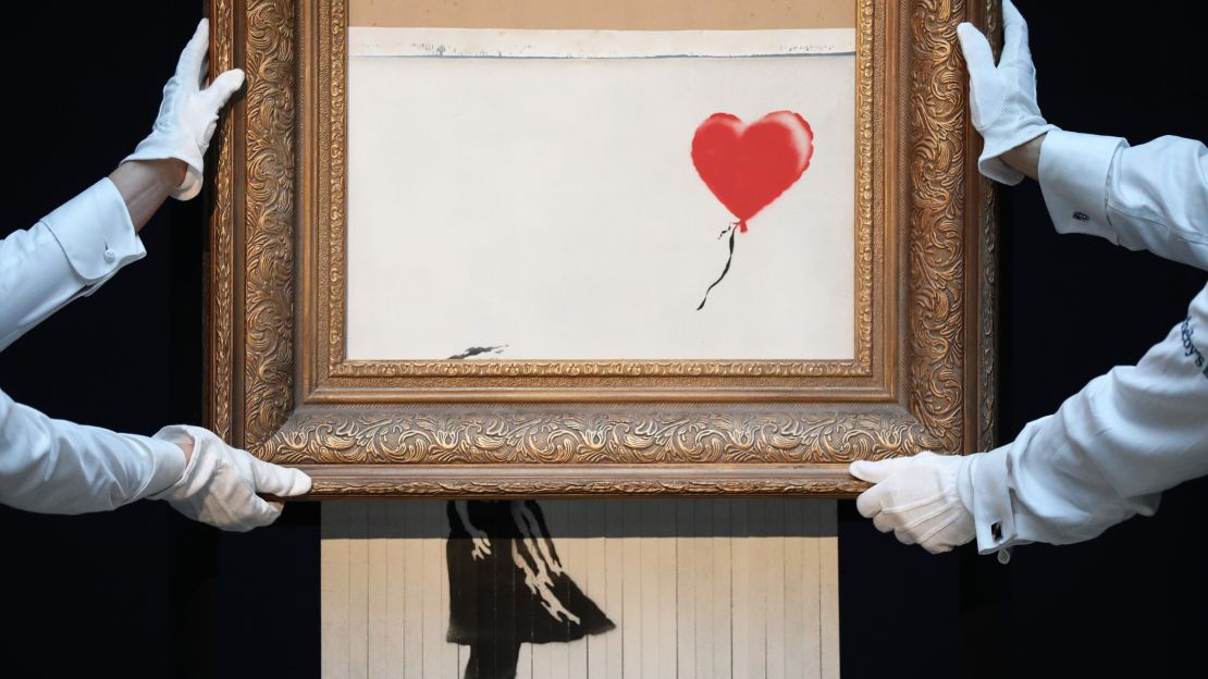 Banksy's 'Love is in the Bin' at Sotheby's in 2018, after the painting passed through a hidden shredder.