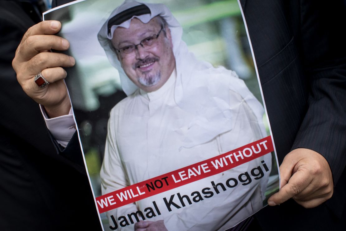 A man holds a poster of  Khashoggi during a protest at the entrance to Saudi Arabia's  consulate in Istanbul on October 8.