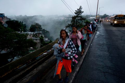 Honduran migrants leave Guatemala City, Guatemala, at sunrise on Thursday, October 18, 2018, as they make their way north toward the United States. Many of the more than 2,000 Hondurans in a migrant caravan trying to wend its way to the United States left spontaneously with little more than the clothes on their backs and what they could quickly throw into backpacks. 