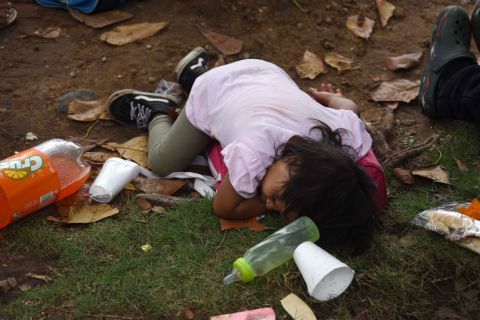 A child lies on the ground to rest as Honduran migrants take part in a caravan to the United States in Teculutan, Guatemala, on Wednesday. 