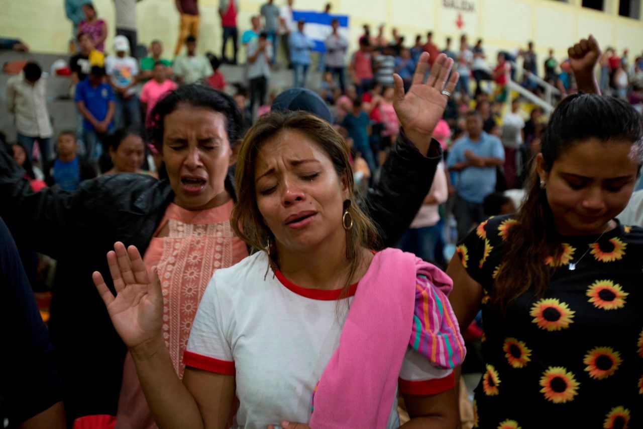 Honduran migrants pray at an improvised shelter in Chiquimula, Guatemala, on Tuesday.