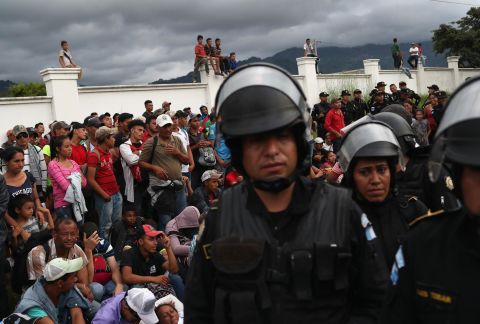 The caravan pauses at a Guatemalan police checkpoint after crossing the border from Honduras on Monday.  