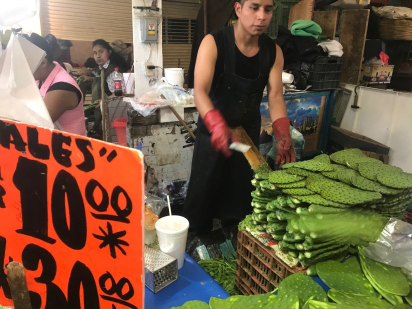 <strong>Prickly pear prep: </strong>A worker methodically -- and rapidly -- shaves the spines off <em>nopales</em>, the ubiquitous prickly pear cactus pads.