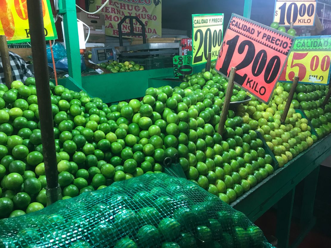 Stacks of limes and avocados bring vivid greens to the multicolored hues of the market.